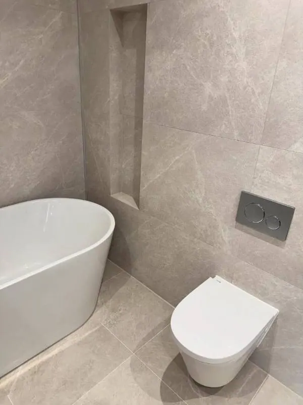 Freestanding bath with clean sealant lines in a family bathroom